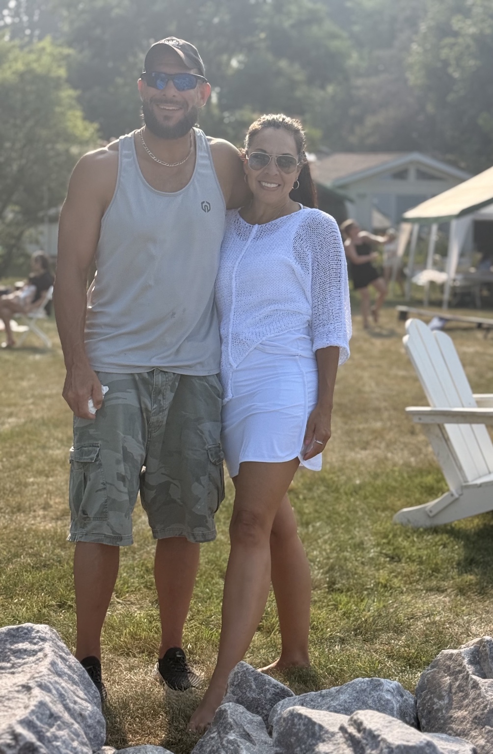 Kat and Glen smiling together at an outdoor gathering