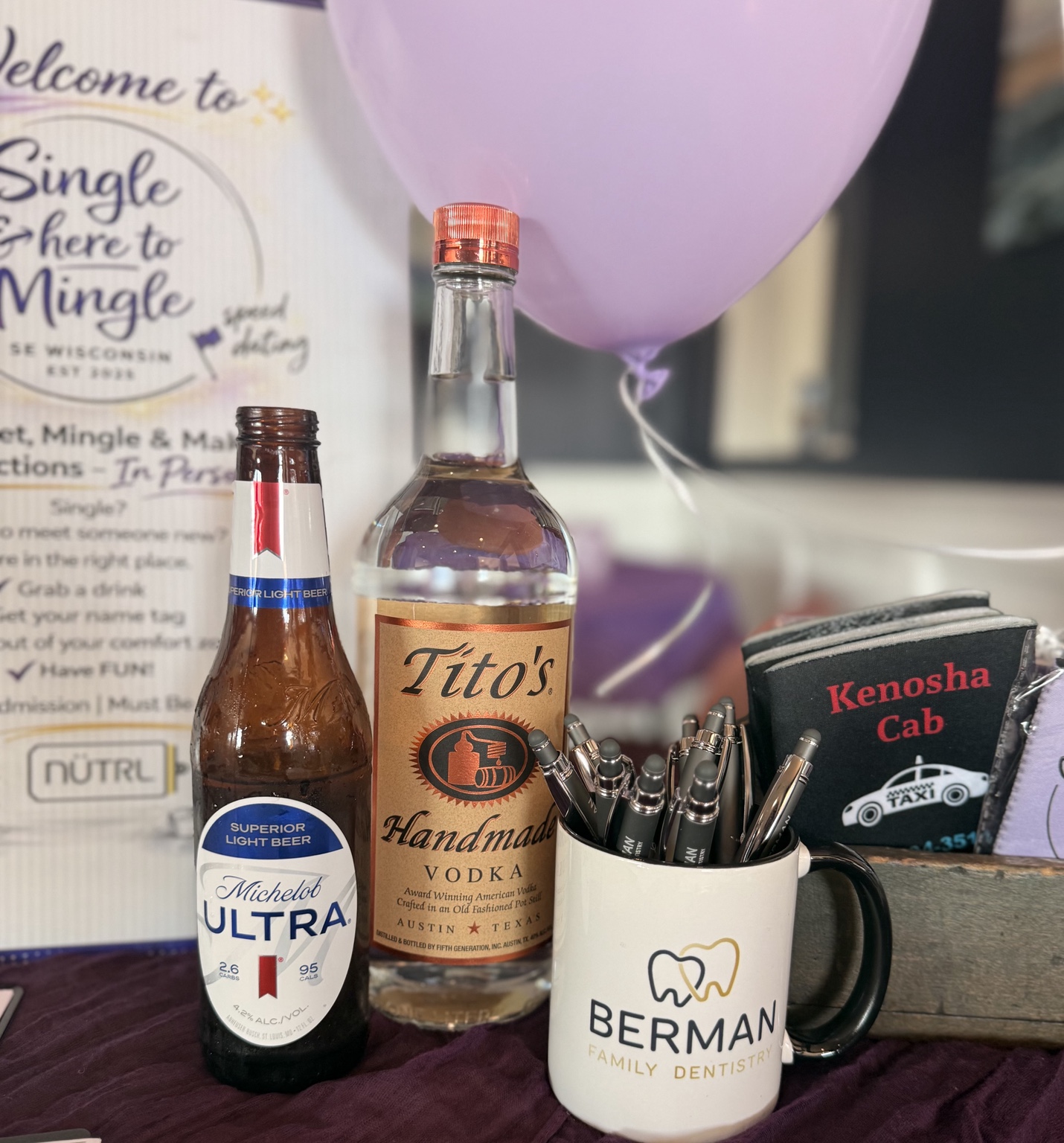 Single & here to Mingle welcome table with sponsor products and event materials