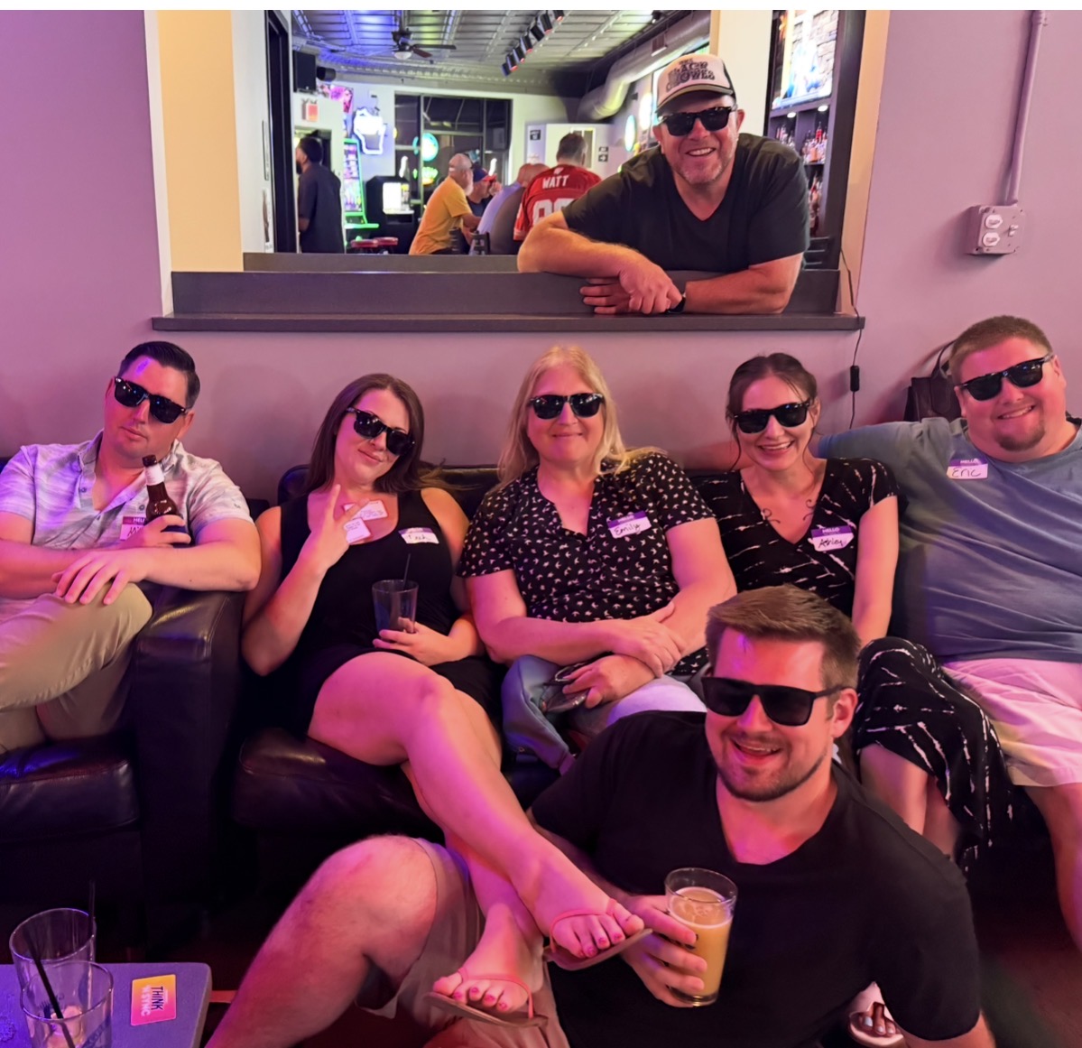 A group of smiling Single & here to Mingle guests wearing sunglasses